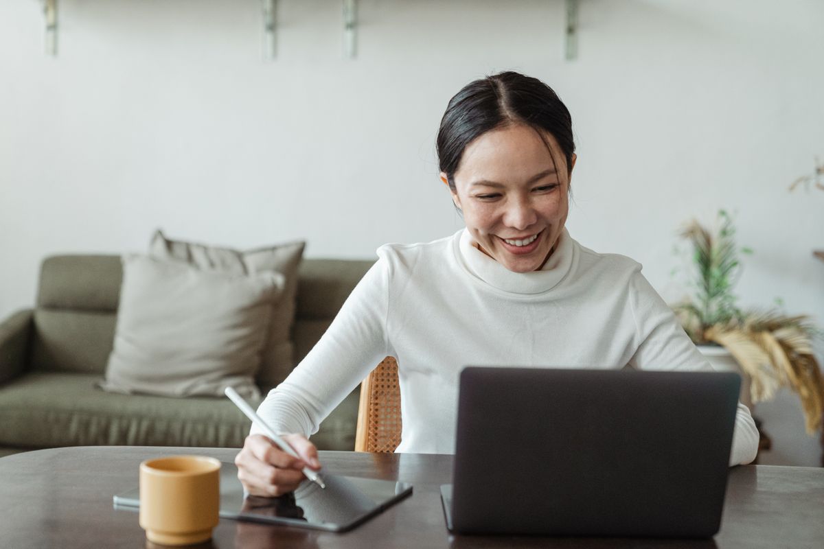 A person speaking on a laptop video call at home.